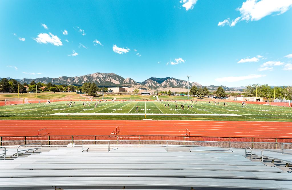 View of the Fairview lacrosse field and stands with the Boulder foothills in the background