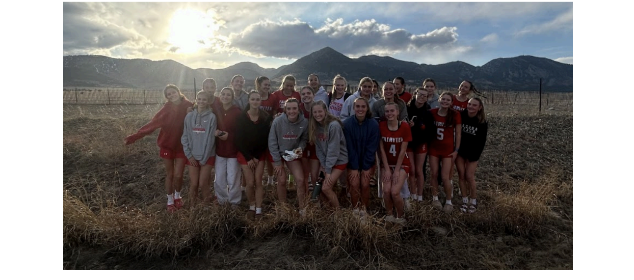 Fairview Knights girls lacrosse team posing together in front of the Boulder foothills